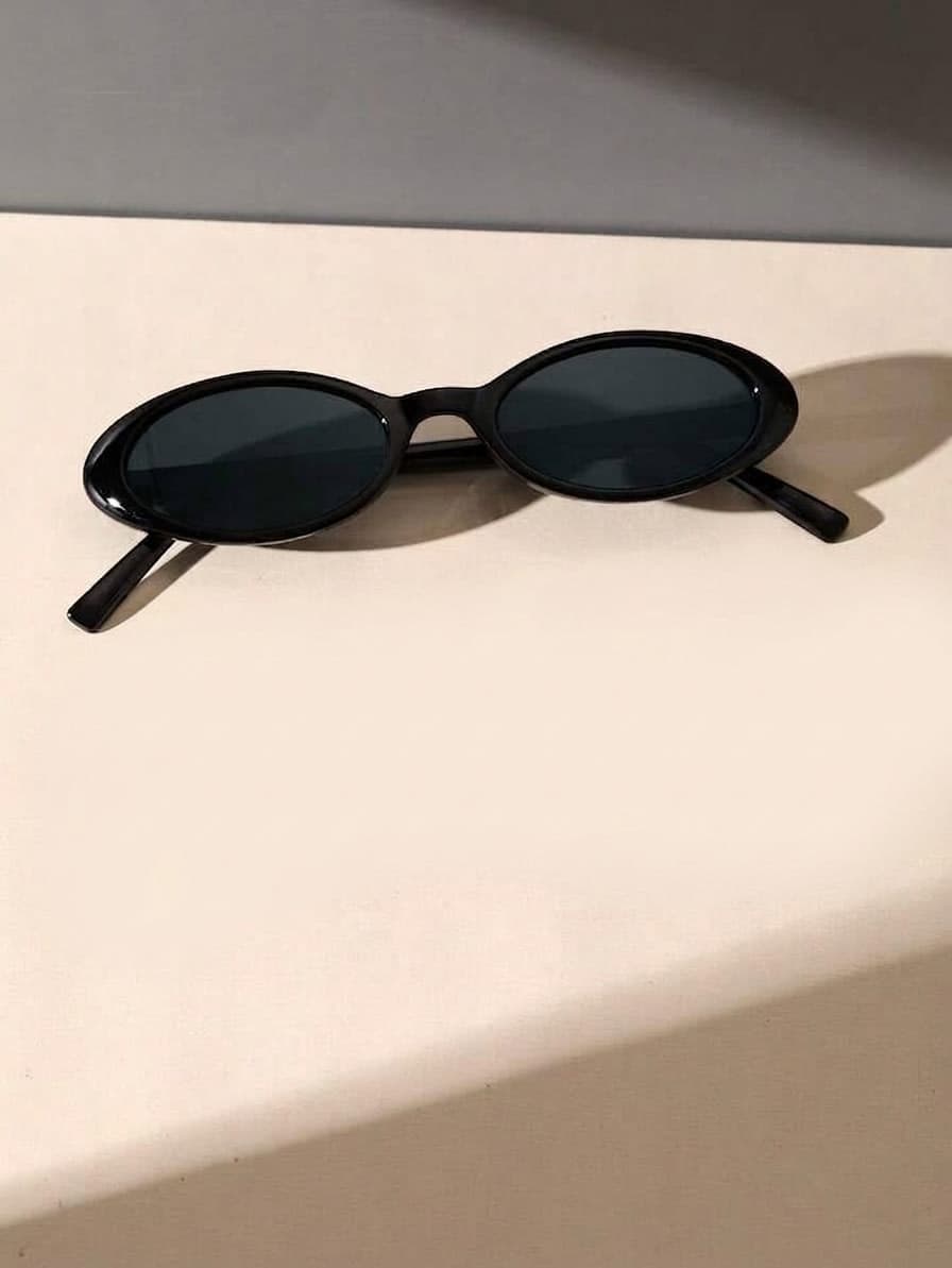 Black Cat Eye Sunglasses Featuring A Glossy Black Plastic Frame And Tinted Black Lenses